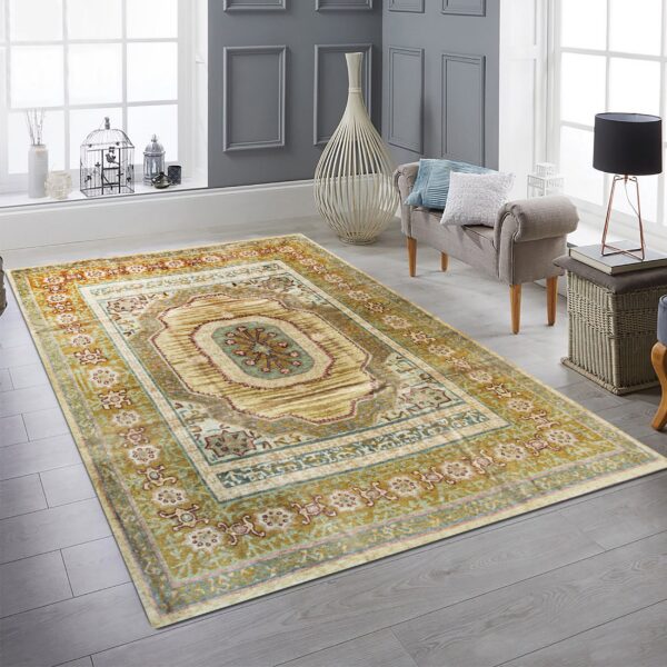 Distressed gold and teal medallion rug anchors a bright room with gray plank floors and window light.