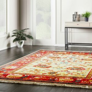 Multi-color traditional rug featuring a cream central field and vibrant red patterned borders on dark hardwood.