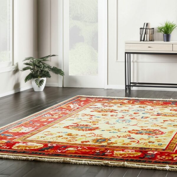 Multi-color traditional rug featuring a cream central field and vibrant red patterned borders on dark hardwood.