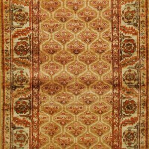 Tan and terracotta runner rug with a repeating trellis field design and detailed floral medallion borders.