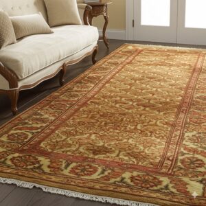 Golden and rust traditional runner rug on dark wood flooring beside a carved light beige sofa.