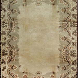 Light beige rug with a scalloped taupe border featuring elaborate brown and cream floral motifs.