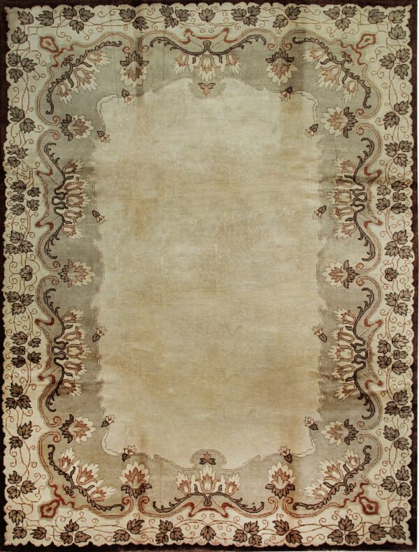 Light beige rug with a scalloped taupe border featuring elaborate brown and cream floral motifs.