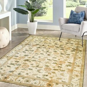 Traditional cream floral rug in a room with light blue walls and a gray armchair.