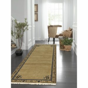 Ornate gold and black runner rug in a bright hallway with white trim and dark wood floors.