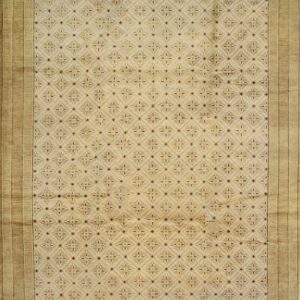 Beige rug featuring a repeating diamond lattice and floral pattern with a wide Greek key border.