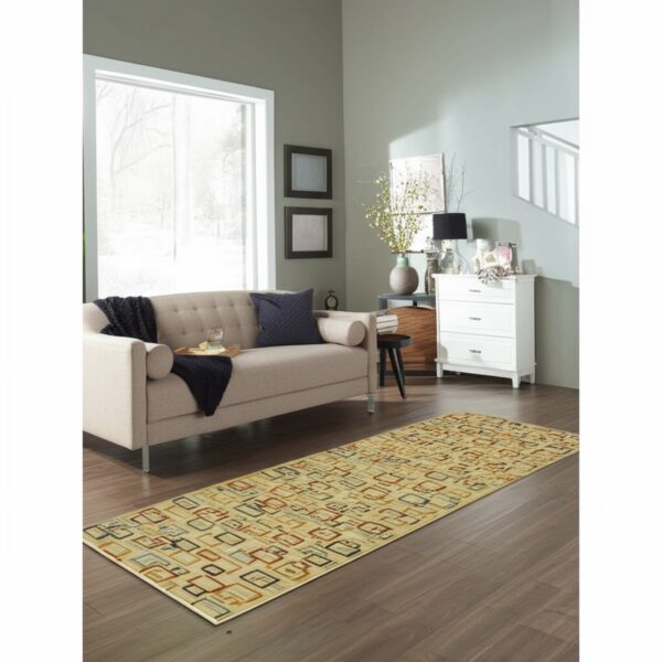 Runner rug featuring beige and multicolored geometric squares placed on dark wood flooring in a bright room.