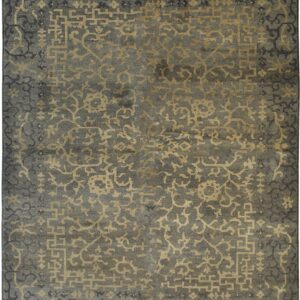 The slate gray rug displays an intricate gold and dark pattern of abstract florals and geometric fretwork.