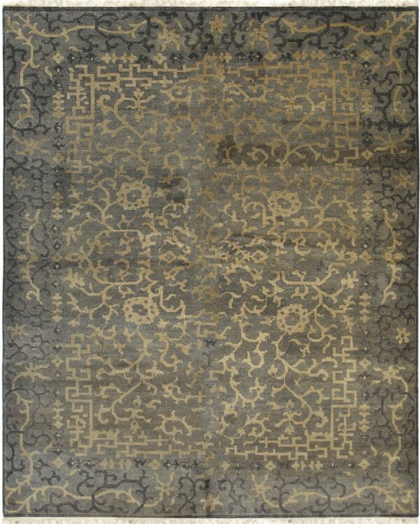 The slate gray rug displays an intricate gold and dark pattern of abstract florals and geometric fretwork.