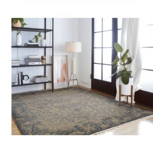 A dark gray rug featuring a distressed golden yellow pattern lays on a hardwood floor.