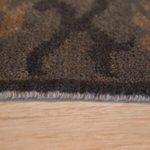 Dark brown textured rug with tan pattern detail rests on light wooden floor planks.