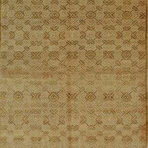 Low-pile gold rug with a detailed repeating brown geometric trellis pattern and white fringe.