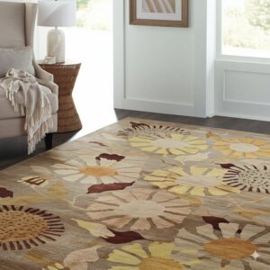 Earth-toned floral rug with yellow and maroon accents on dark wood floors in a well-lit living space.