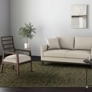 Olive green abstract rug grounds a living area featuring a light beige sofa and a dark wood accent chair.