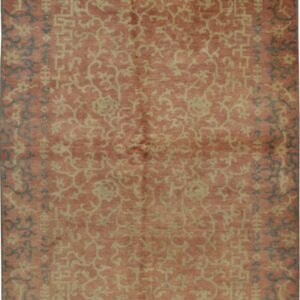 Rectangular rug with a rose field, featuring beige geometric and scrolling patterns with dark gray border accents.