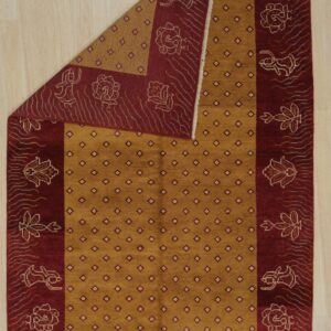 Mustard yellow rug with geometric lattice and deep red border featuring stylized figures and flowers.