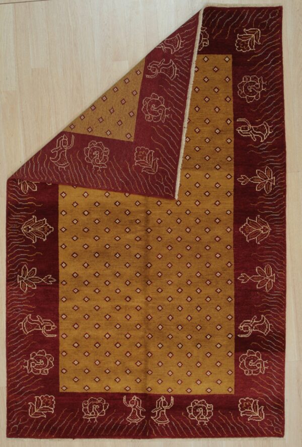 Mustard yellow rug with geometric lattice and deep red border featuring stylized figures and flowers.