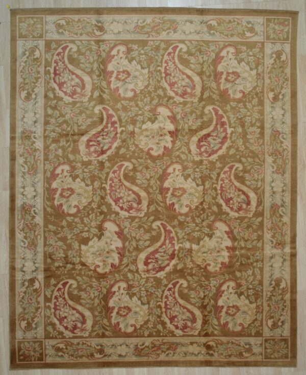 Earthy brown rug featuring repeating red and cream paisley designs with a multi-layered floral border.