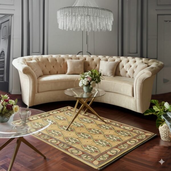 Gold and green medallion rug rests on dark wood floor, flanked by a curved beige tufted sofa.
