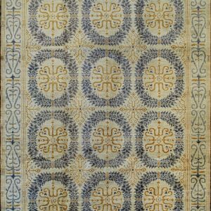 Pale rug with repeating indigo and gold medallion patterns, surrounded by a complex scrolling vine border.