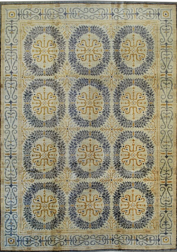 Pale rug with repeating indigo and gold medallion patterns, surrounded by a complex scrolling vine border.