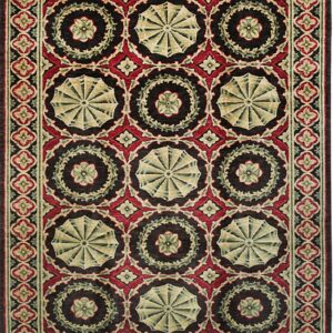 A richly patterned rug featuring dark brown, red, and green medallions and floral motifs in repeating rows.