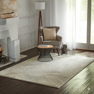 Light-colored geometric rug on dark hardwood floors anchors a sitting area with a gray chair and white brick.