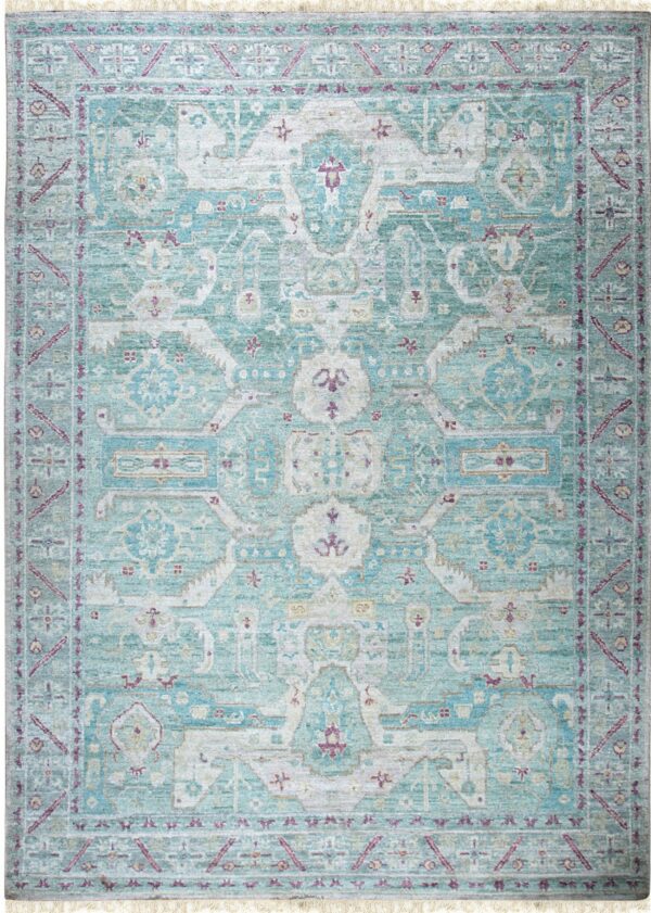 Distressed teal and cream area rug featuring a traditional medallion pattern and short fringe.