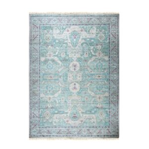 Muted teal, cream, and magenta traditional rug with a central medallion and detailed borders.