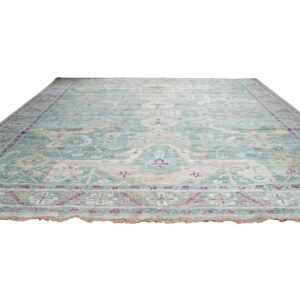 Teal and cream distressed rug with subtle magenta accents, shown on a white background.