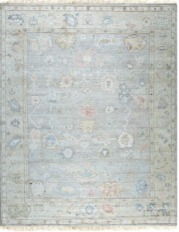 Traditional pale blue and sage rug with pastel pink and yellow floral motifs and light fringe.