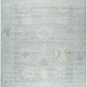Light blue and gray low-pile rug with an abrash finish and a subtly faded traditional pattern.