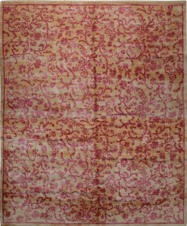 Full view of a golden tan rug featuring a dense all-over magenta floral vine pattern and subtle border.