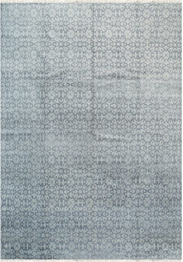 Repeating stylized floral pattern rug in muted blue and light gray with short white fringe.