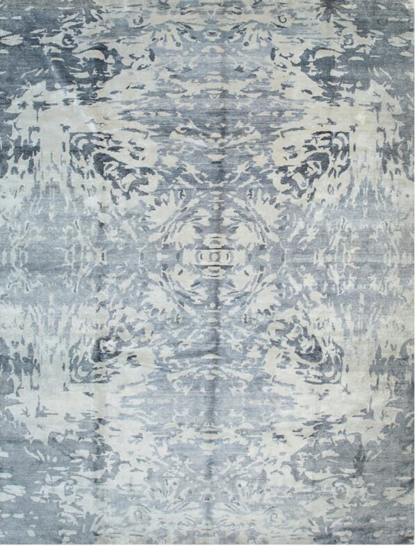 Symmetrical abstract rug featuring distressed dark gray and light beige patterns with a visible luster.