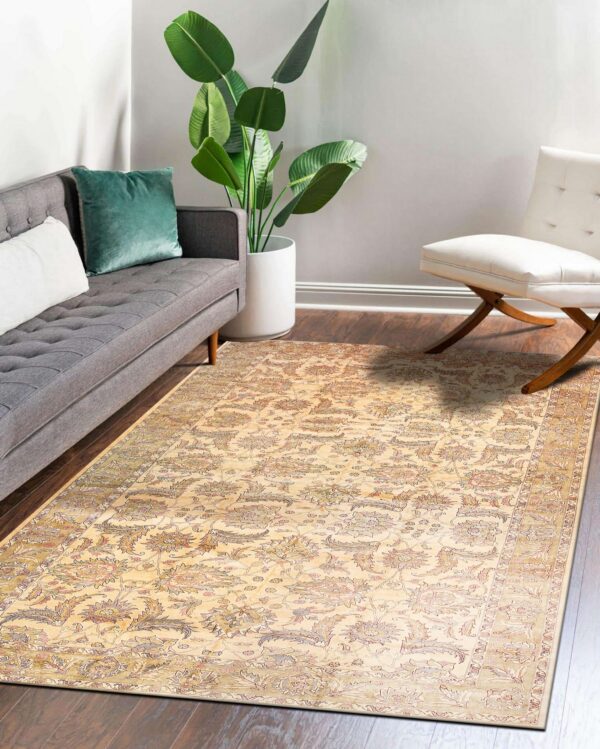 Traditional beige and multicolored floral rug on dark wood floors in a room with a gray sofa.