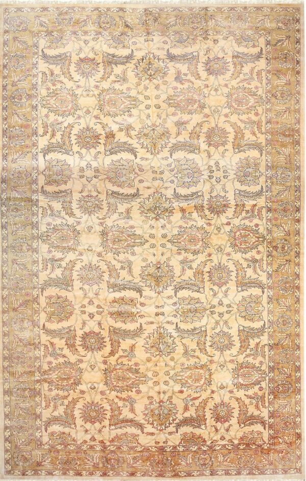 Traditional gold and cream rug with an all-over floral and vine pattern and fringed edges.