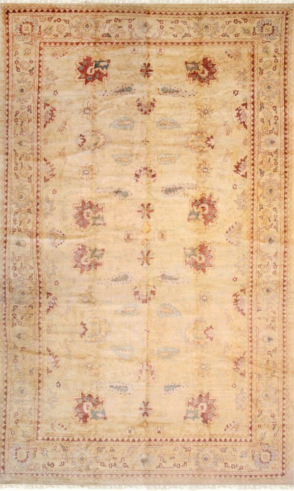 Pale yellow rug with scattered traditional motifs in red and blue, framed by an intricate border.