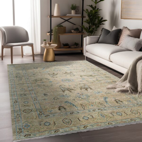 A muted beige and blue traditional area rug anchors a living room with modern furniture.