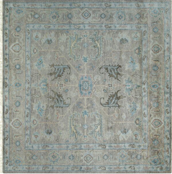 Medium-pile square rug with traditional patterns in taupe, light blue, and dark brown.