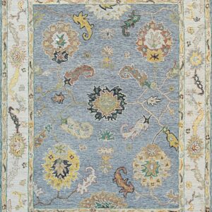 Textured blue rug with an ivory border and traditional floral designs in yellow, rust, and green.