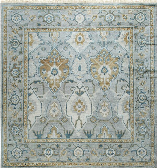 Traditional gray rug with ornate borders and patterns in gold, teal, and off-white.