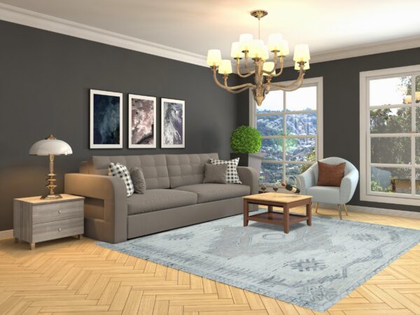 Distressed light blue rug featuring a faded traditional pattern on a natural wood floor.