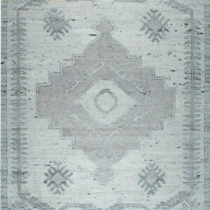 High pile rug with a geometric diamond pattern and tribal border in cream and gray tones.