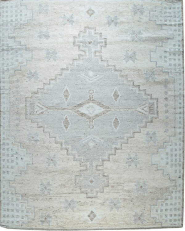 Cream and gray geometric rug with a large stepped medallion and tribal motifs on a textured pile.