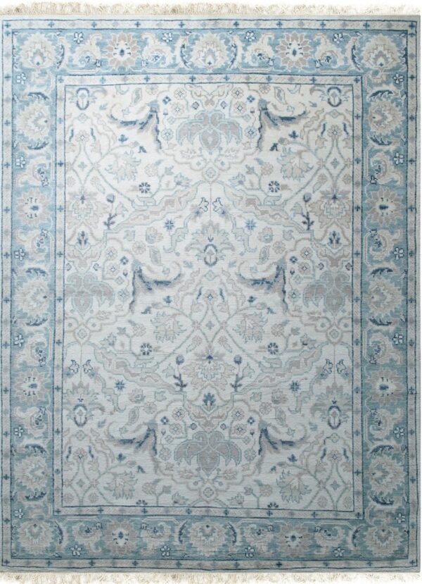 An off-white traditional rug with complex blue and beige floral medallions and fringe ends.