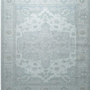 Light blue and pale gray traditional rug featuring an elaborate central medallion design and visible fringe ends.