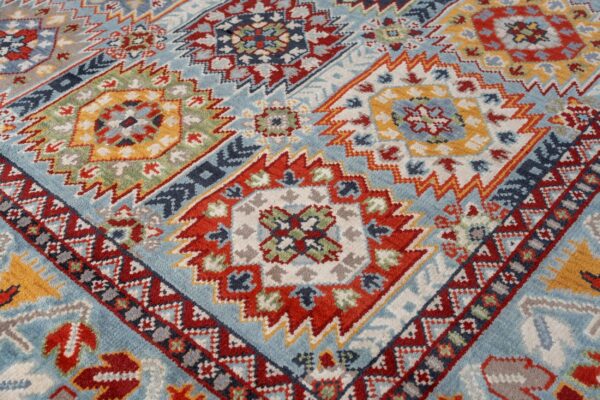 Close-up of a medium pile rug featuring a colorful geometric pattern on a light blue background.
