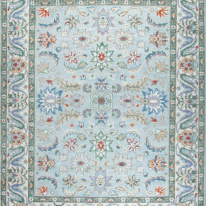 Ornate pale blue rug with a dense floral pattern and complex white, green, and lavender borders.