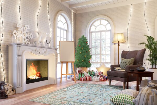 Light blue and red traditional rug on wood floor anchors a bright room with a fireplace and christmas tree.